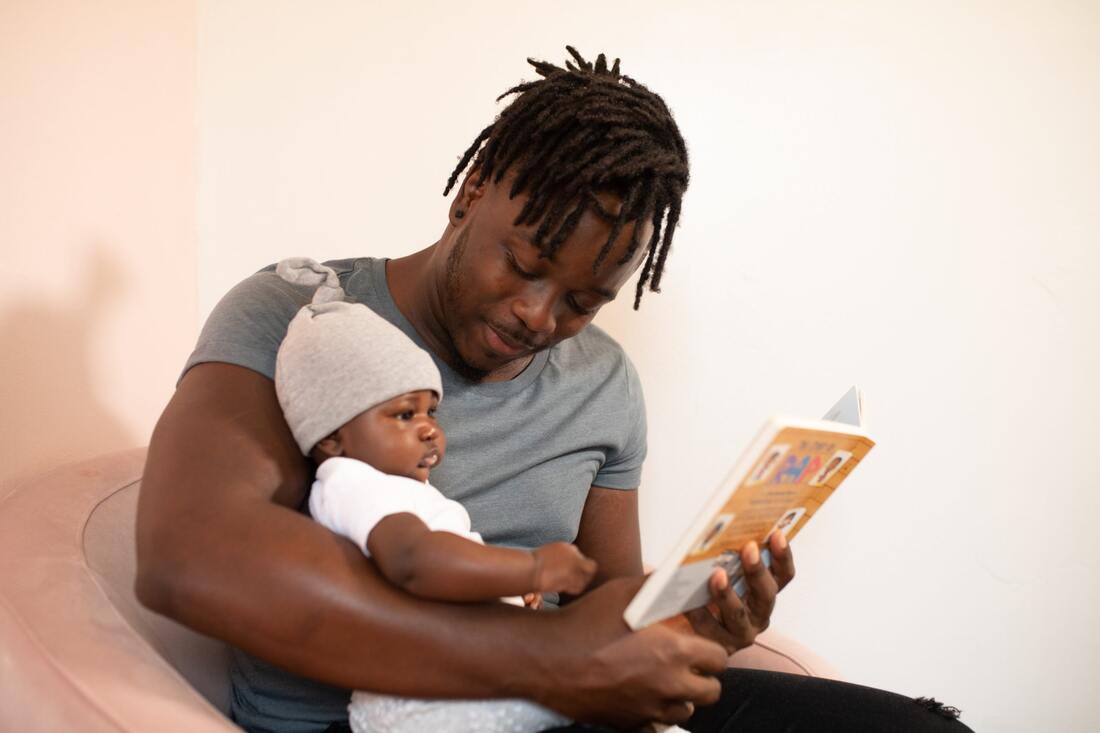 Father and baby reading a book